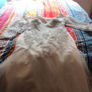 Brand new! Size 14W off shoulder wedding gown